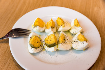Boiled eggs with salt pepper and olive oil
