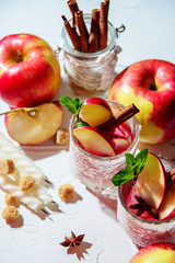 mulled wine in fishnet glasses on a light background, Apple, cinnamon, wine