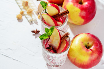 mulled wine in fishnet glasses on a light background, Apple, cinnamon, wine