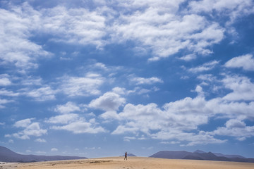 Fototapeta na wymiar Single man walk in the fuerteventura desert
