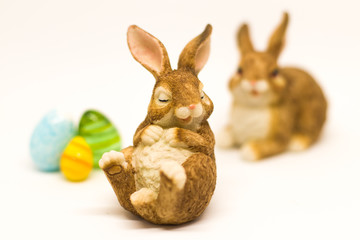 Fototapeta na wymiar Sleepy easter bunny with friend and glass eggs