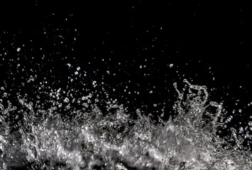 Water splash transparent on black background with copy space, sparkling water drops detail, shot...