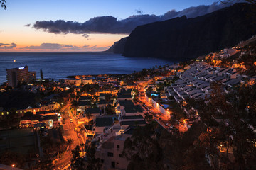 Fototapeta premium residential apartments in the background of Los Gigantes Cliffs, Tenerife, Spain