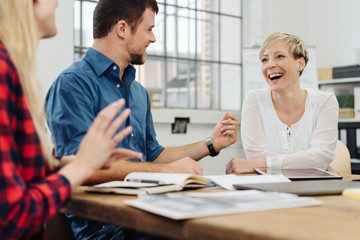 Happy motivated business team enjoying a laugh