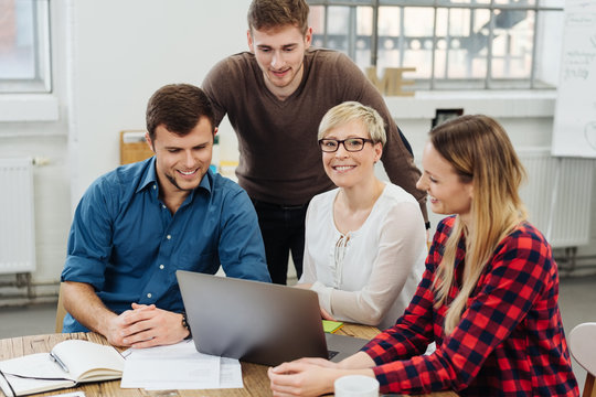 Confident successful young team leader