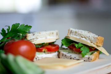 Delicious healthy sandwiches for lunch with fresh vegetables from farmers market on a kitchen table
