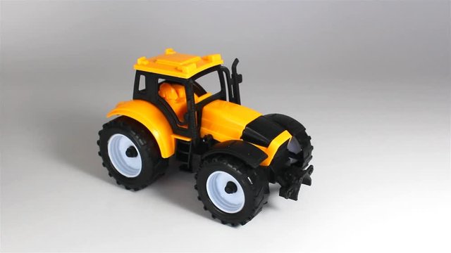 Yellow tractor ride and stop in front on white background