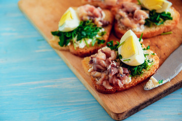 bruschetta, appetizer, canapes: fish and spinach on toast of white bread, with egg