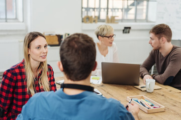 Fototapeta premium Four business colleagues deep in conversation