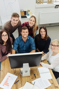 Motivated young business team at a desktop
