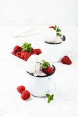 Sweet summer ice cream with raspberry on the white stone background