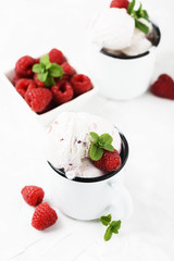 Sweet summer ice cream with raspberry on the white stone background