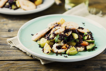 Black rice with prawns, vegetables and orange