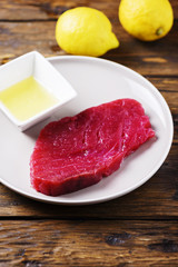Raw fresh tuna fish on the wooden table