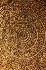 Pattern of flower carved on wood background.