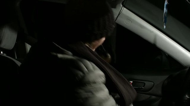 Woman Getting Into Car On A Cold Night