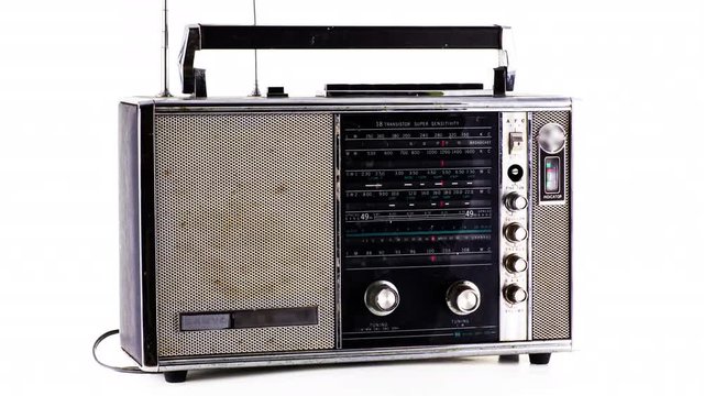 a selection of vintage ghettoblasters and radios spinning around. it is filmed in a way that the objects change as they rotate. this version has added glithc and distortion effects overlayed