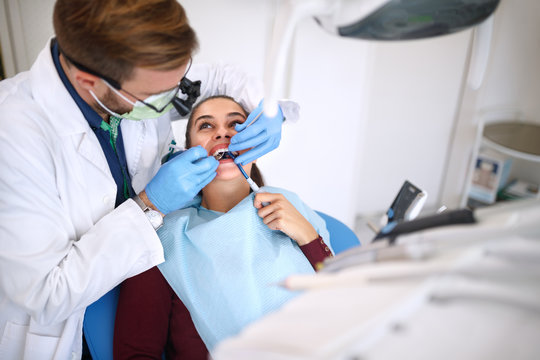 Dentist repairing girl’s tooth