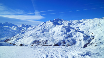 Skiing, snowboard slopes, on snowy mountain peaks in 3 Valleys winter resort, Alps, France .
