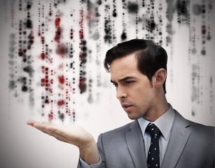 Handsome businessman holding hand out over matrix