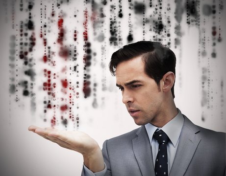 Handsome businessman holding hand out over matrix