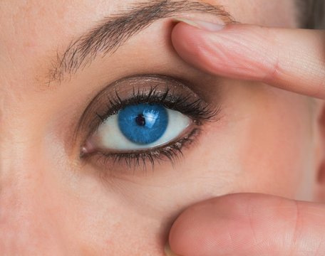 Woman stretching her eye