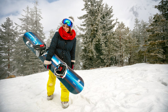 girl with snowboard outdoors -winter resort