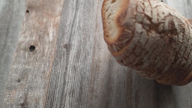 Sliced sourdough bread falling on a table. Shot with high speed camera, phantom flex 4K. Slow Motion.