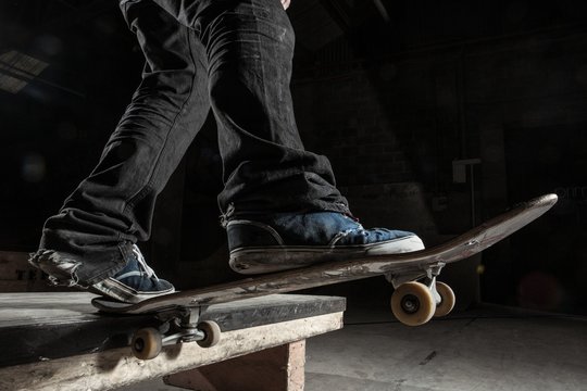 Skater balancing on edge on manual pad