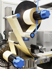 Fragment of the conveyor of the pharmaceutical labeling machine. Abstract industrial background.