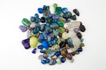Top view of various tumbled bright coloured semi precious gemstones