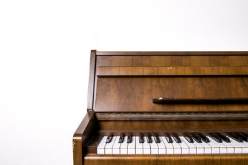 old piano in front of white wall