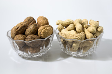 Walnuts and peanuts in a crystal glass