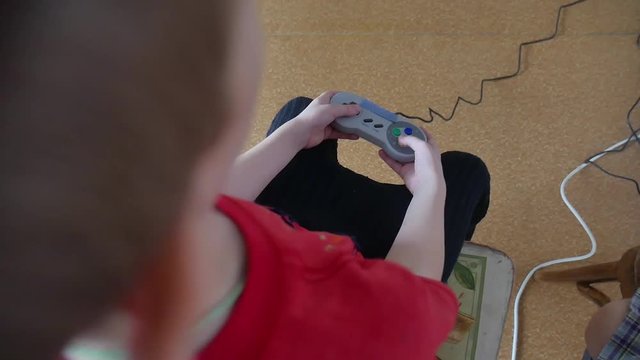 Boy teen playing video games on the console