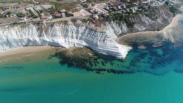 High altitude aerial bird view of Scala dei Turchi in english Stair of the Turks this rocky cliff on coast of Realmonte in southern Sicily Italy has become a popular tourist attraction 4k quality