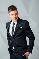 Portrait of handsome stylish man in elegant suit