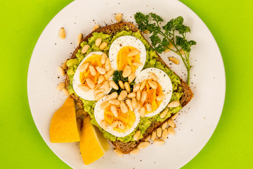 Boiled Egg on Crushed Avocado With Pine Nuts And Rye Bread Open Faced Sandwich