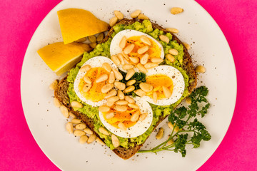 Boiled Egg on Crushed Avocado With Pine Nuts And Rye Bread Open Faced Sandwich