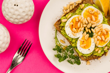 Boiled Egg on Crushed Avocado With Pine Nuts And Rye Bread Open Faced Sandwich