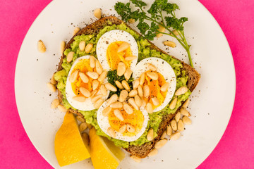Boiled Egg on Crushed Avocado With Pine Nuts And Rye Bread Open Faced Sandwich