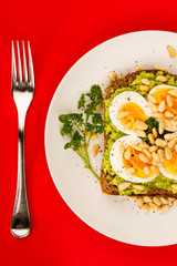 Boiled Egg on Crushed Avocado With Pine Nuts And Rye Bread Open Faced Sandwich