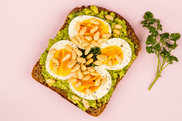 Boiled Egg on Crushed Avocado With Pine Nuts And Rye Bread Open Faced Sandwich