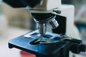 Close up shot of  scientist working with microscope in laboratory.