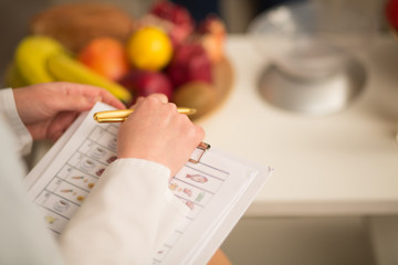 Close up image of note book and pen of dietitian. Healthy life style concept.