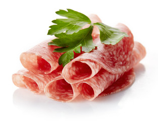 Sliced summer sausage on white background