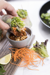 Thai vegetarian fresh rolls dipping in peanut sauce