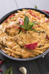 Close up of Thai red curry in a black bowl