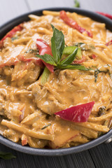 Close up of Thai red curry in a black bowl