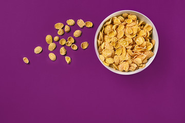 Bowl with cornflakes on the colorful background