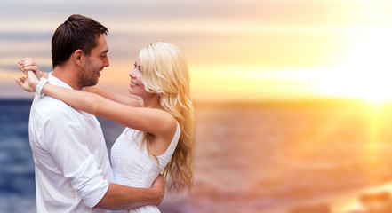 happy couple hugging over sea background